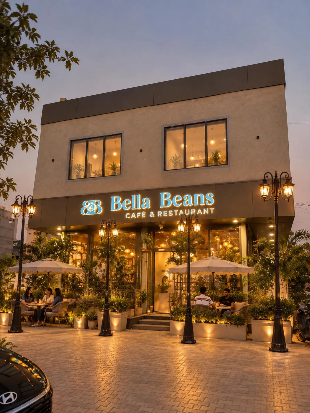 The Bella Beans café front glowing warmly at dusk